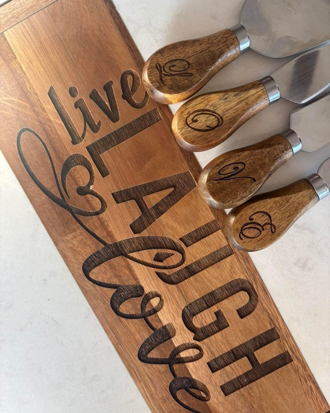 Engraved wooden serving board reading Live Laugh Love