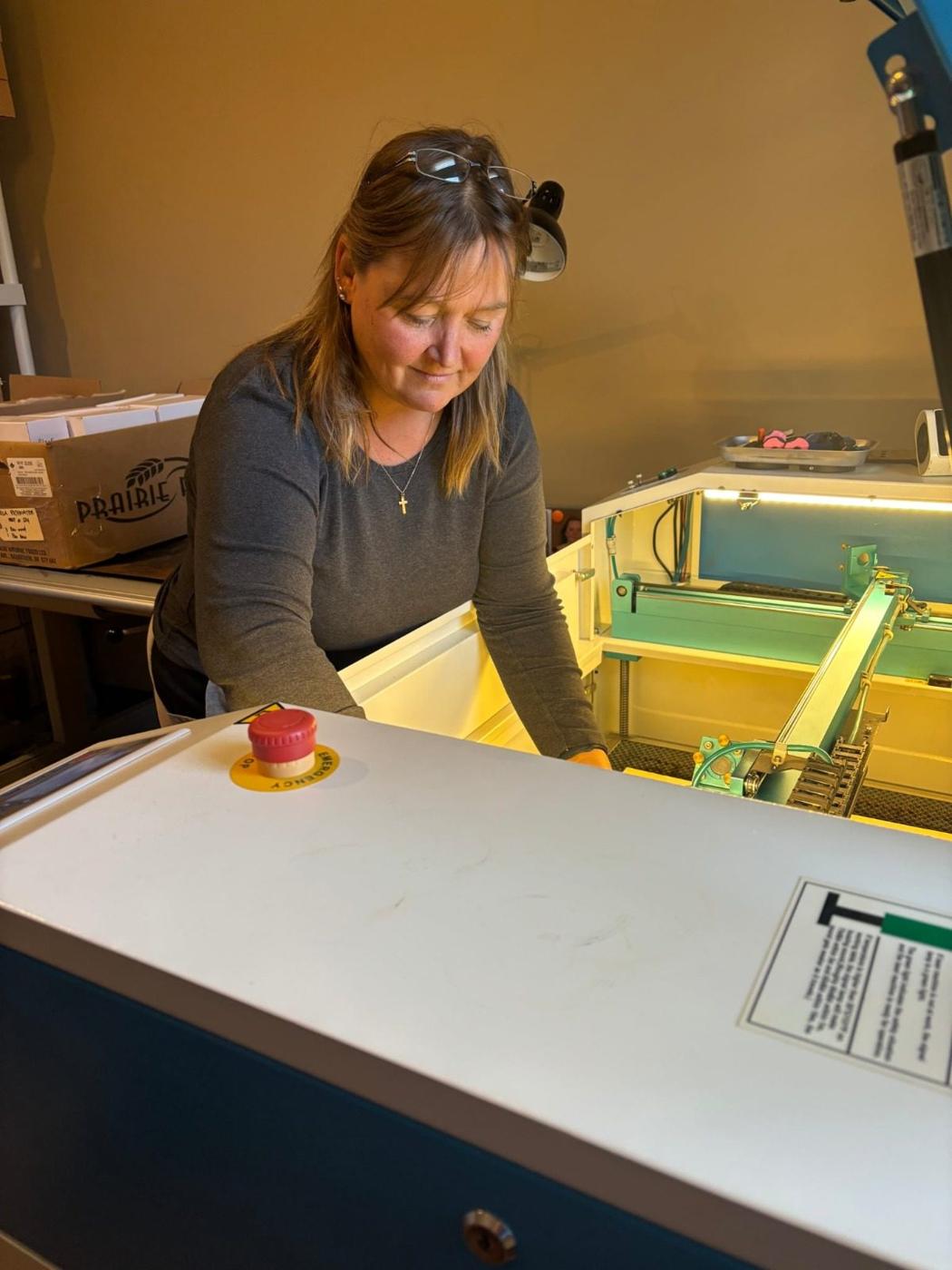 Sheila working at the laser in the Wild Touch Engraving shop