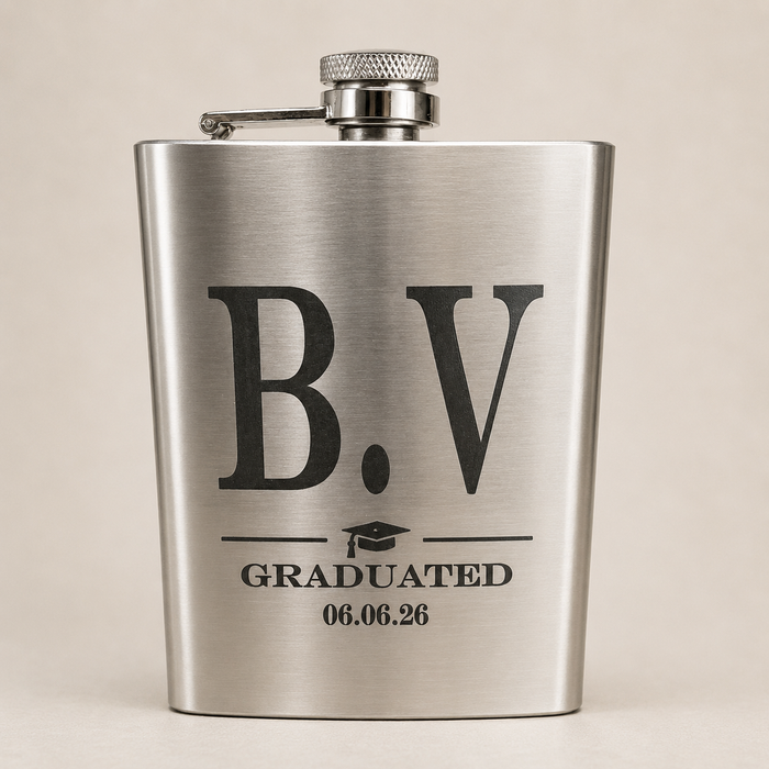 A brushed stainless steel flask with a personalized graduation design featuring the letters 'B.V', a graduation cap icon, and the text 'GRADUATED 06.
