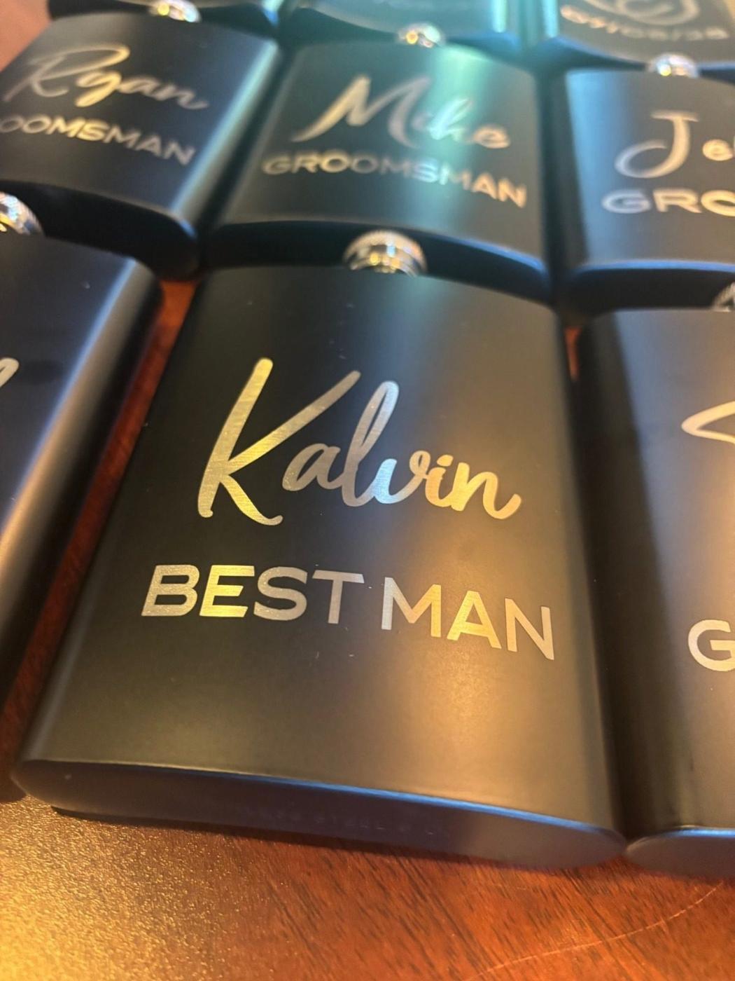 Matte black flasks engraved with gold groomsman names
