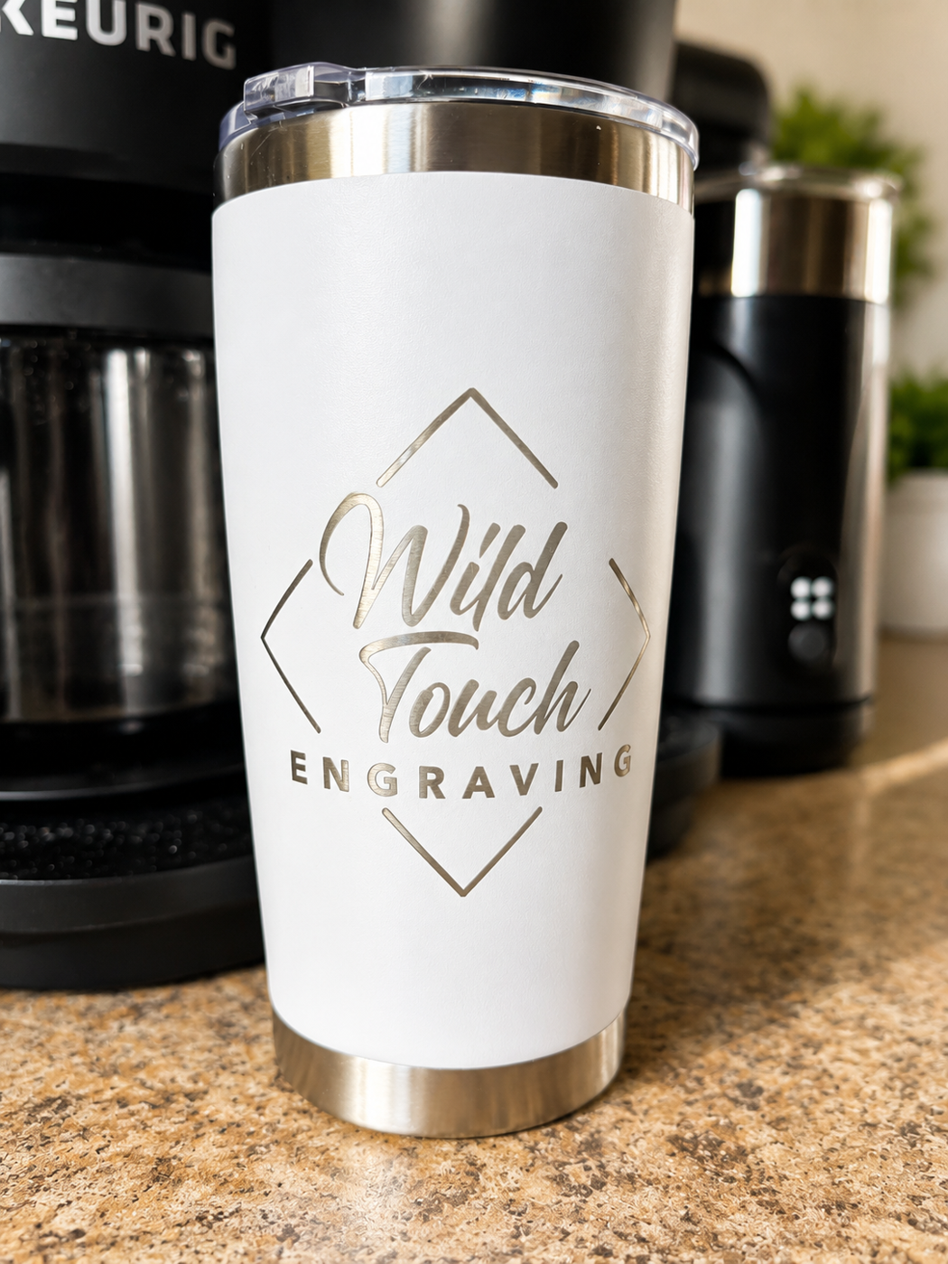 White tumbler engraved with the Wild Touch Engraving logo